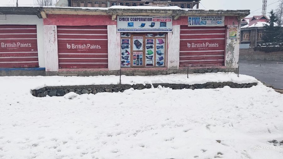 Cyber Corporation store front under fresh snowfall in Kashmir